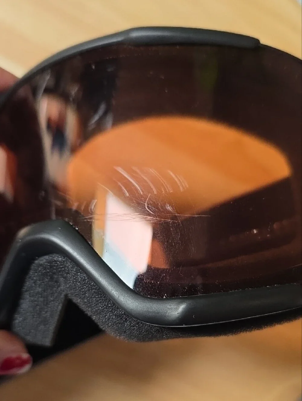 Smith Optics snow goggles featuring a black strap with white branding
